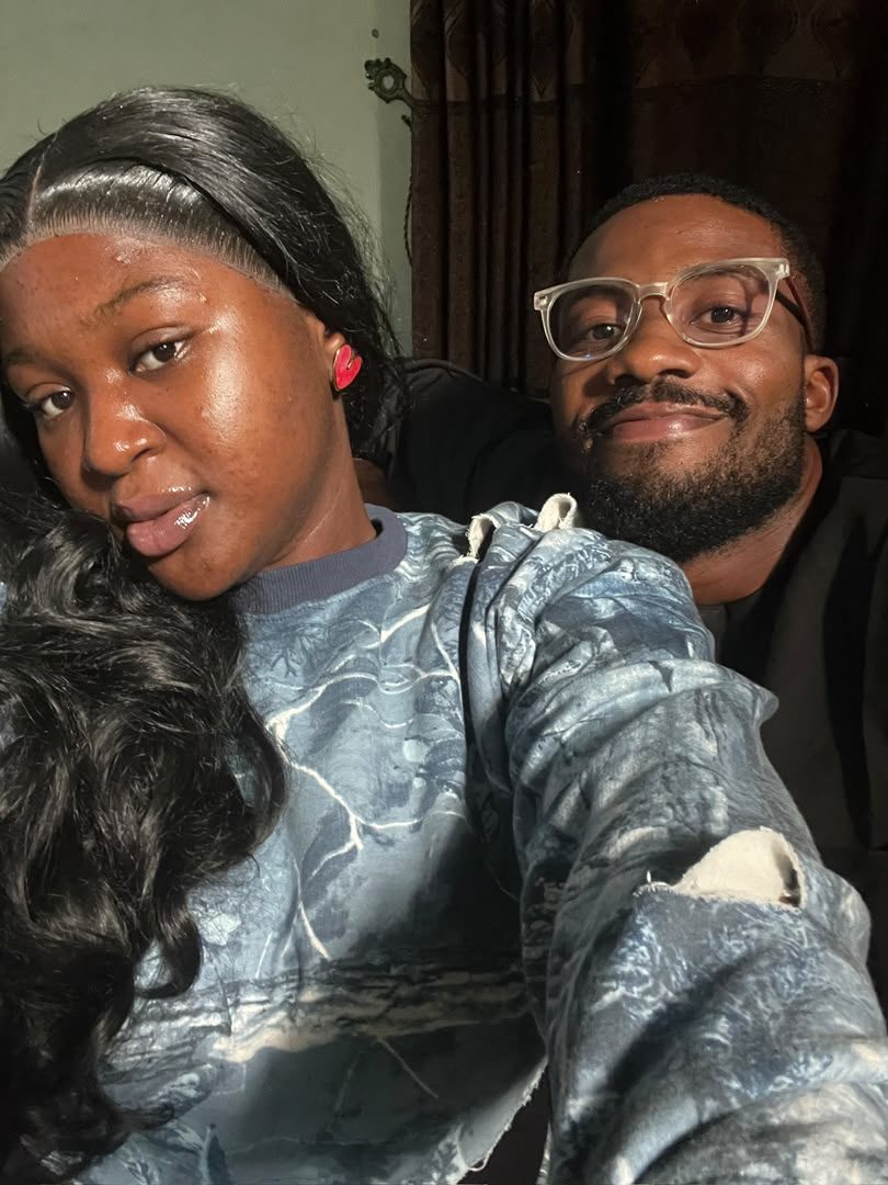 Nnenna and Chukwuma cheek to cheek in a warm room