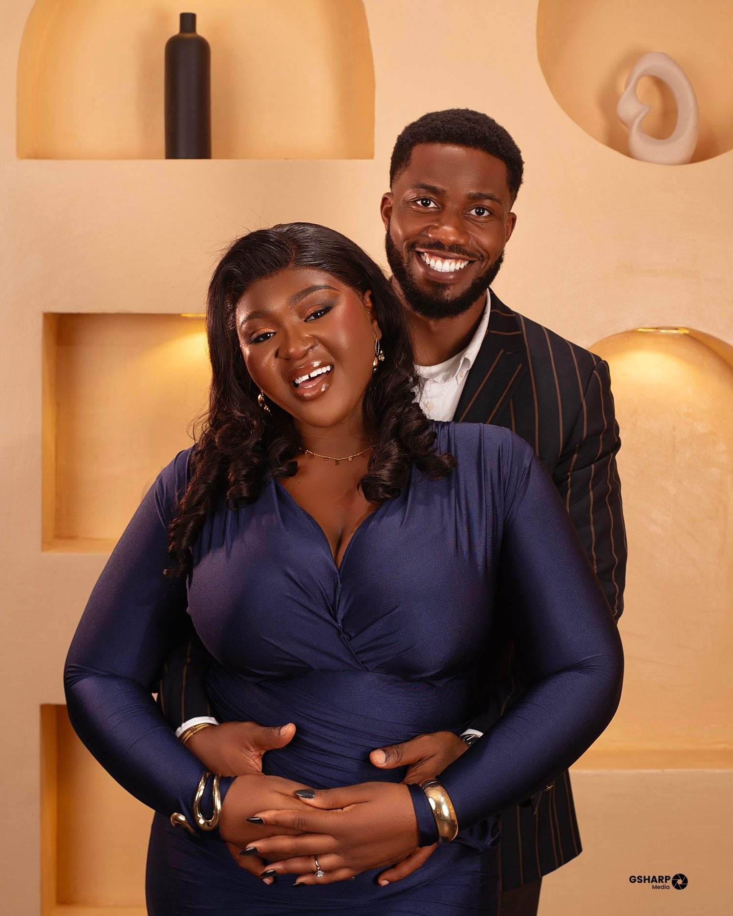 Chukwuma holding Nnenna close in the engagement portrait